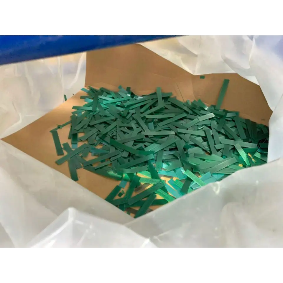 Bag of green plastic strips for plastic strapping recycling in strap shredding machine