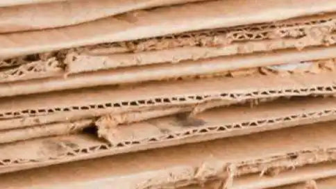 Stacked corrugated cardboard sheets.